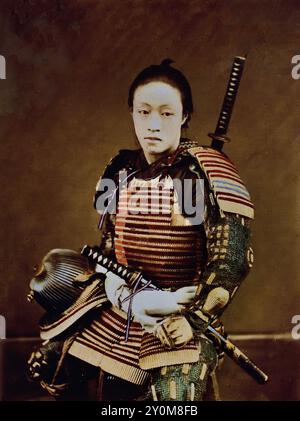 Portrait of Samurai in armour 1873-1875 by Suzuki Shin`ichi I .his is a Japanese hand-coloured black-and-white photo from the late 19th to the beginning of the 20th century. It is a vintage albumen photograph, digitally improved. Japanese hand-coloured black-and-white photo Japan late 19th—beginning of 20th-century vintage albumen photograph ( Historic History ) digitally enhanced reproduction. Stock Photo